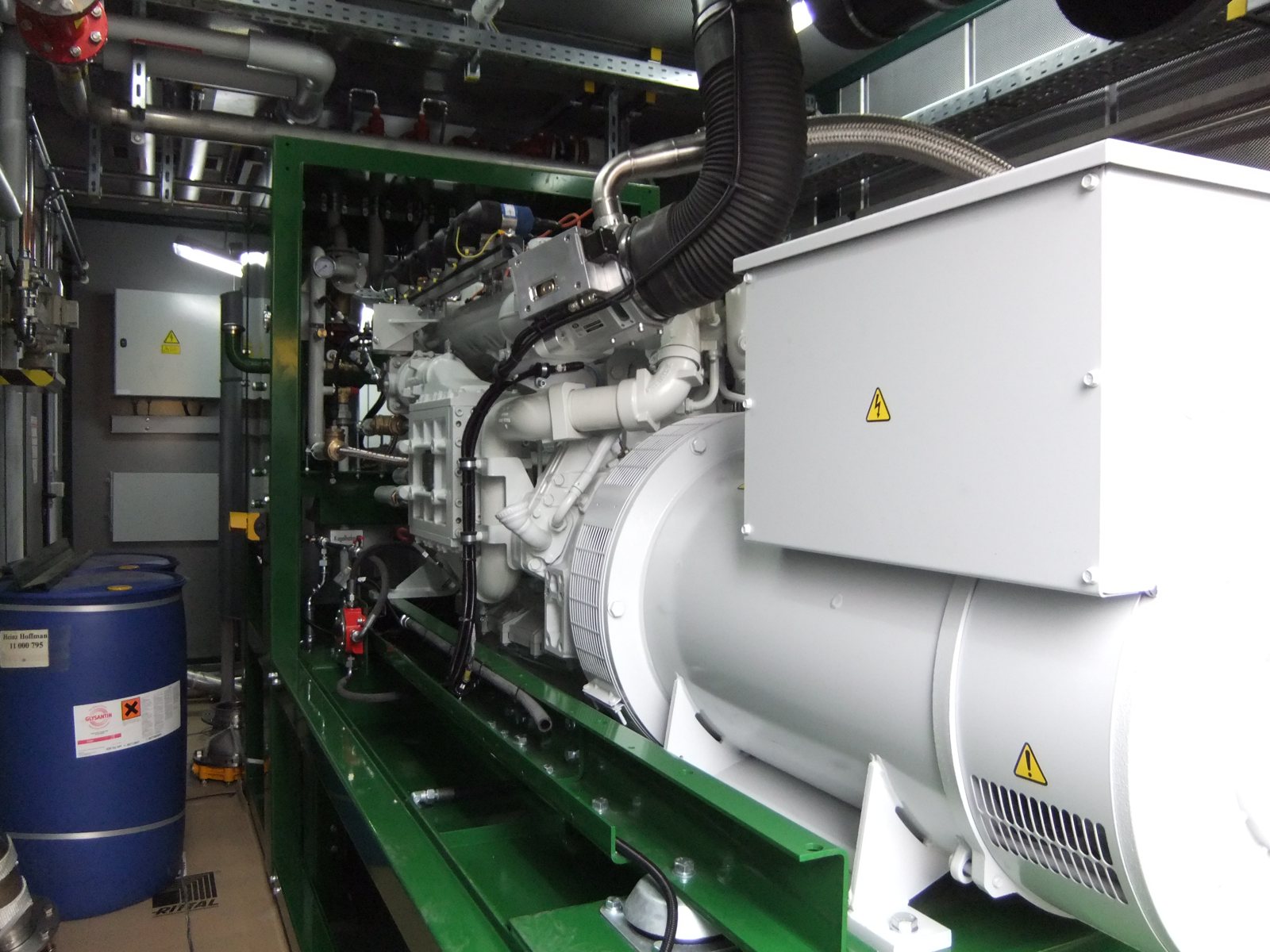 A real gas engine-generator: engine on a green frame coupled to a white generator